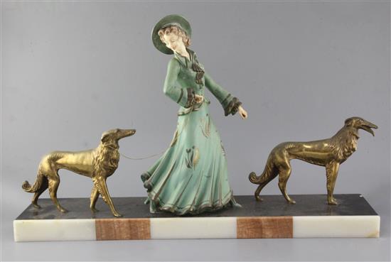 George Maxim (1895-1940). A French Art Deco painted and gilt spelter group of an elegant lady and two borzois, 26.5in.